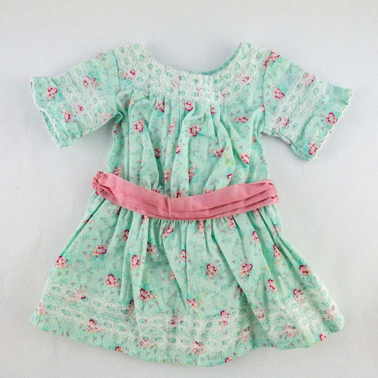 American Girl doll dress set including green floral doll dress with lace trim and pink bow sash, pink bow headband, white stockings, and red patent shoes image 2