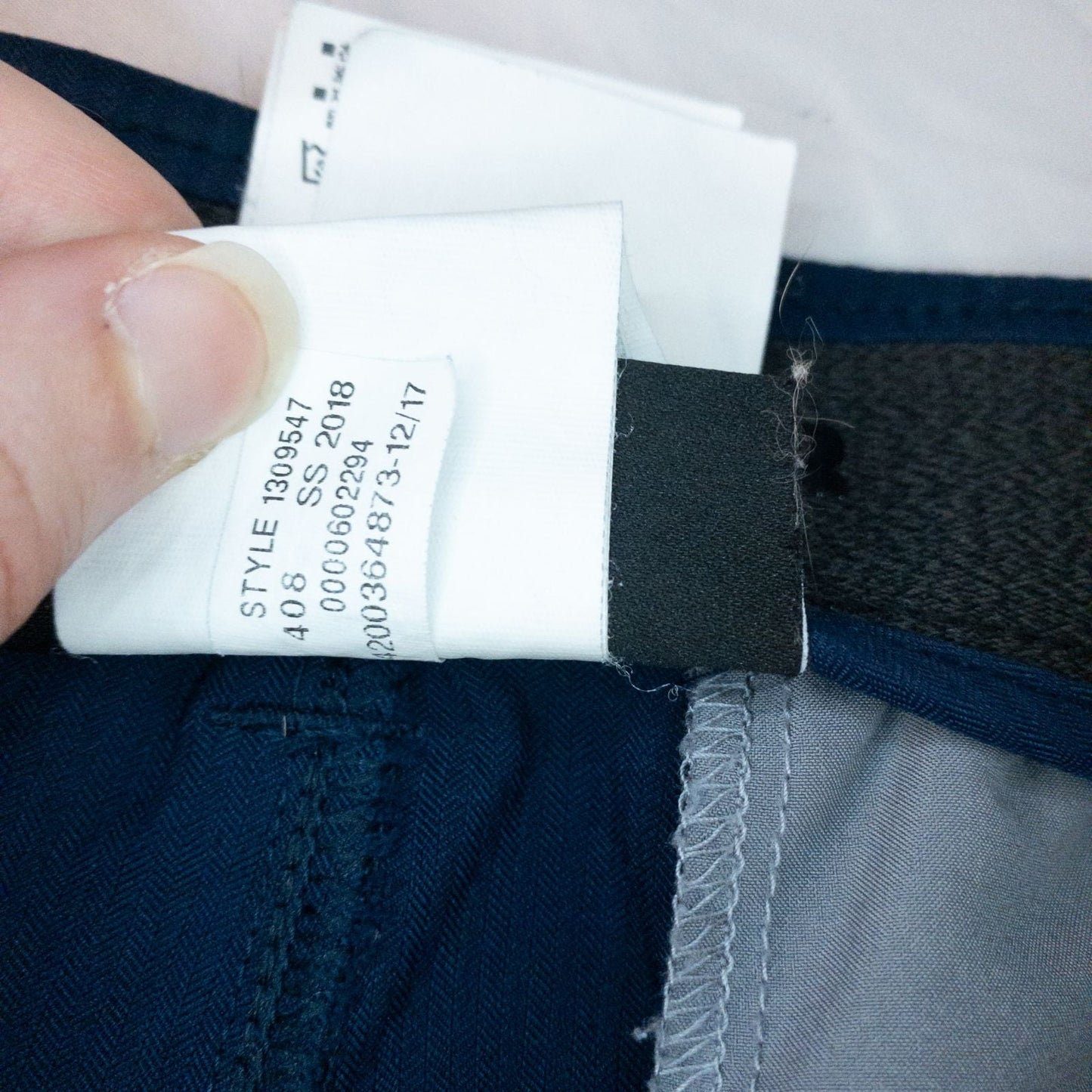 Under Armour navy men's shorts laid flat showing front and back views with button and logo details image 15