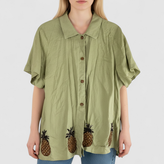 Vintage beaded pineapple linen short sleeve shirt in muted green with wooden buttons and detailed beadwork on pineapples on model