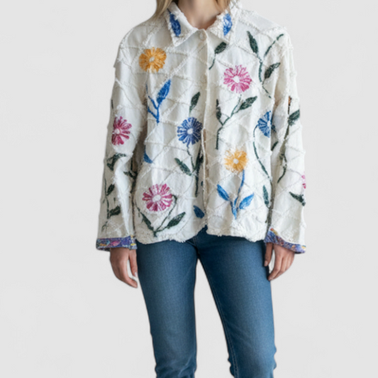 Keren Hart vintage embroidered flower jacket in white with multicolor floral embroidery on a woman and hanging on hangers on model