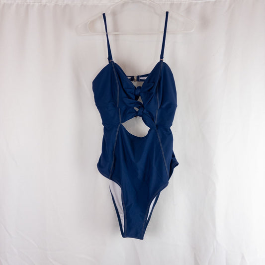 Blue Cupshe one piece swimsuit with cutout and knot detailing front view on hanger