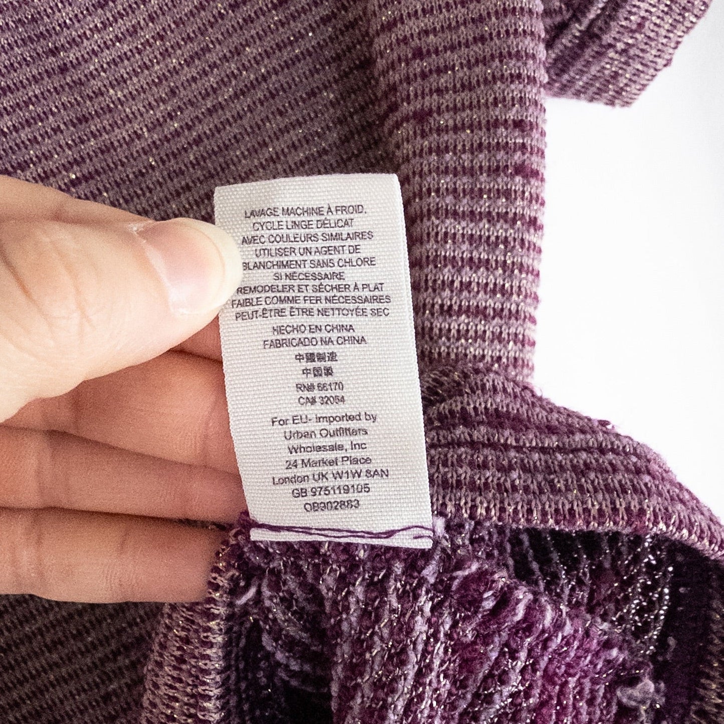 Free People knit purple and gold short puff sleeve sweater top on hanger against white background image 9