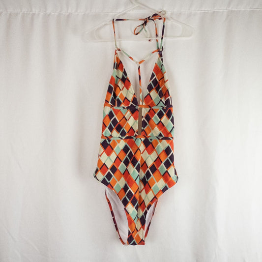 Orange teal geometric diamond pattern Cupshe one-piece swimsuit with halter neck and cutout detail shown hanging on white hanger
