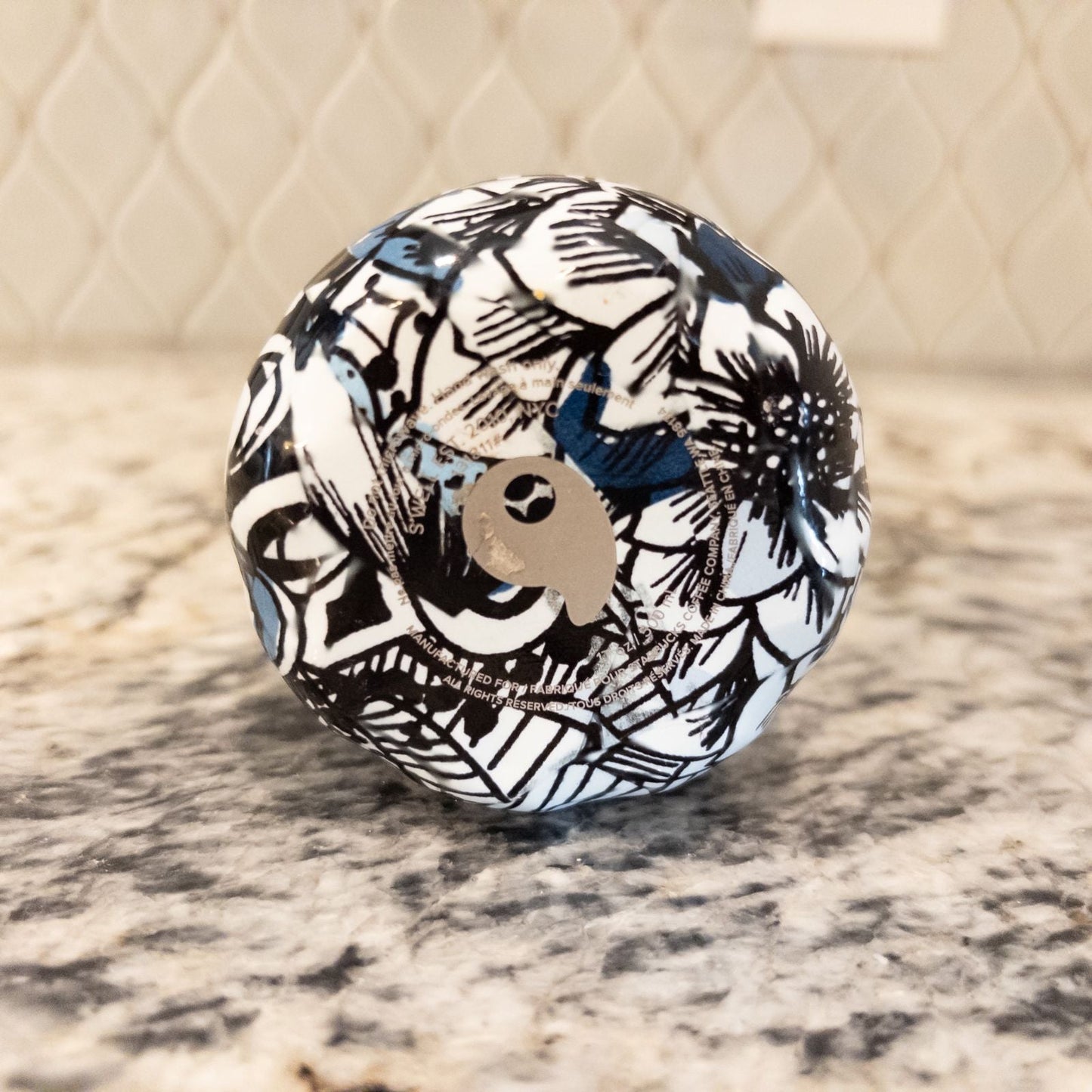 Starbucks Swizzle bottle with black white and blue artistic floral abstract print on countertop image 13