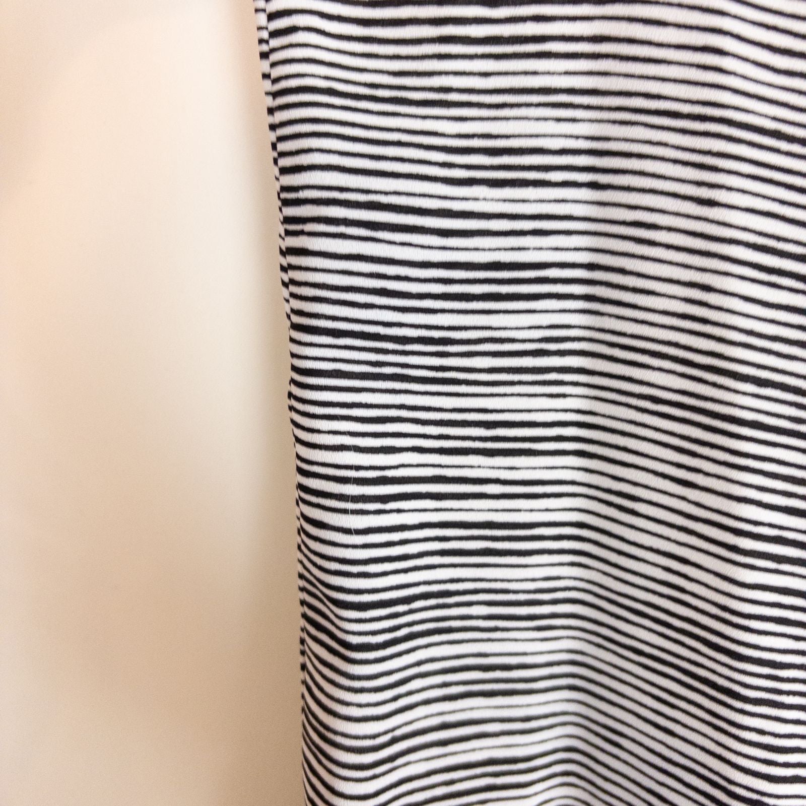 Elle black and white striped sleeveless tank top with peplum hem on clear hanger image 3