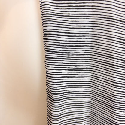 Elle black and white striped sleeveless tank top with peplum hem on clear hanger image 3