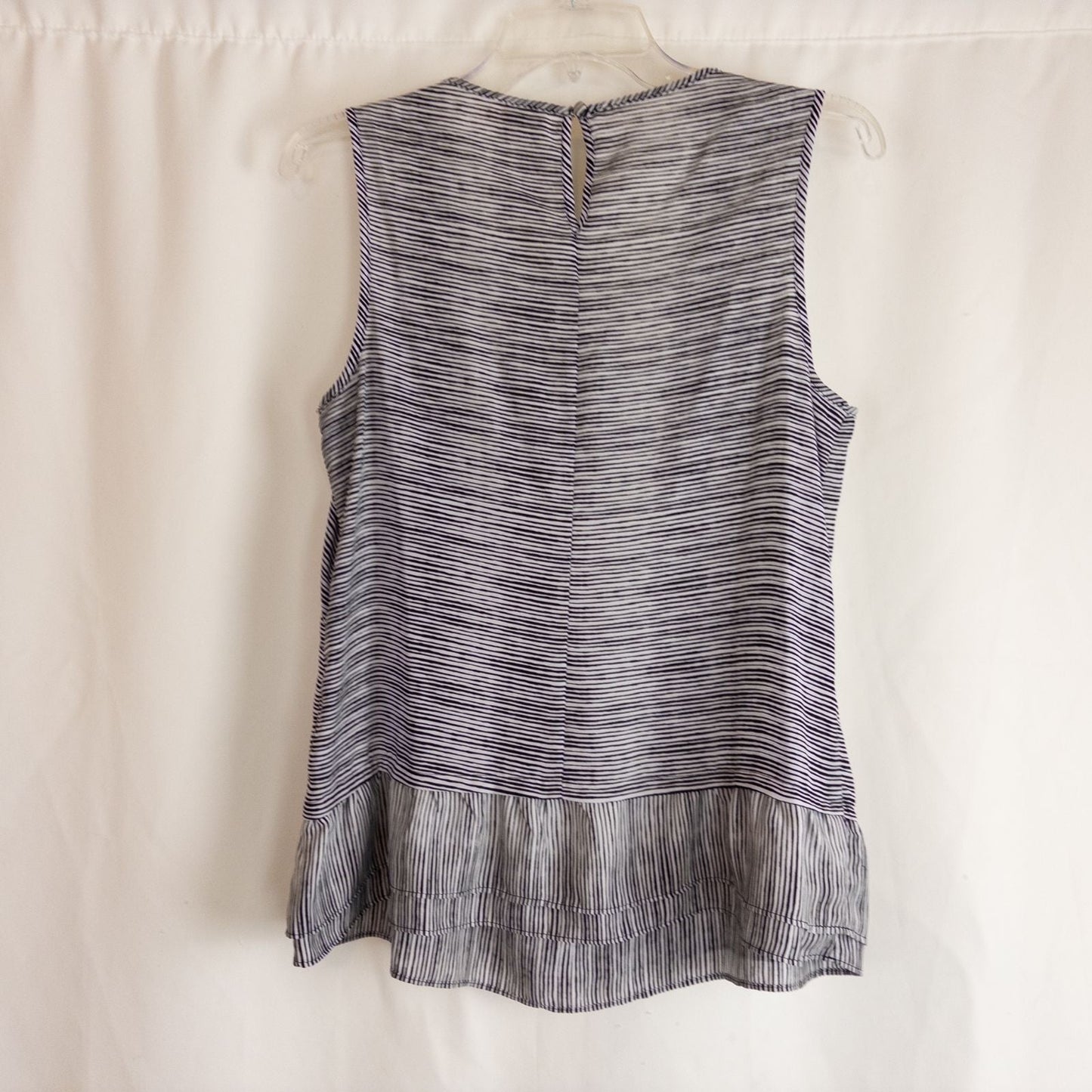 Elle black and white striped sleeveless tank top with peplum hem on clear hanger image 4