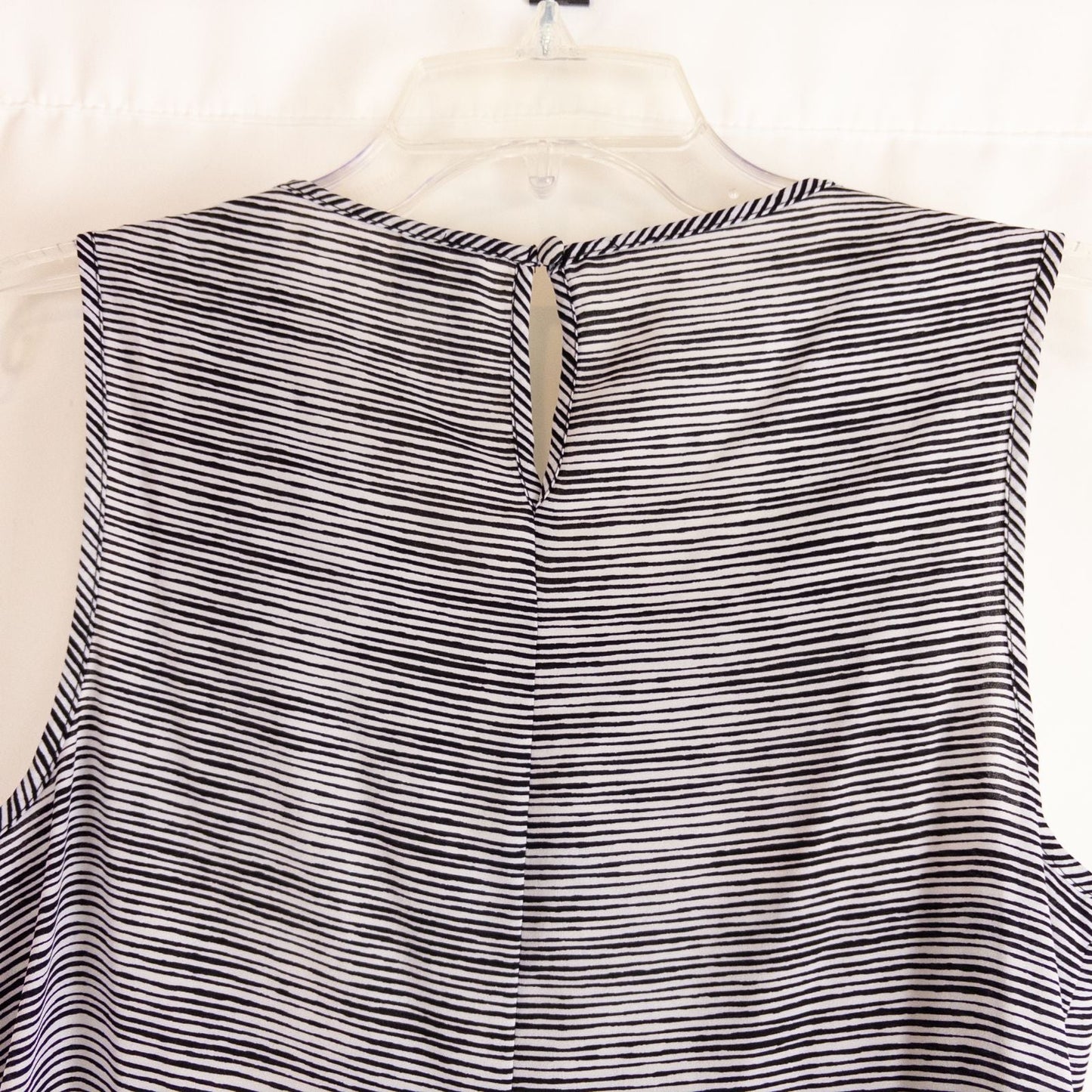 Elle black and white striped sleeveless tank top with peplum hem on clear hanger image 5