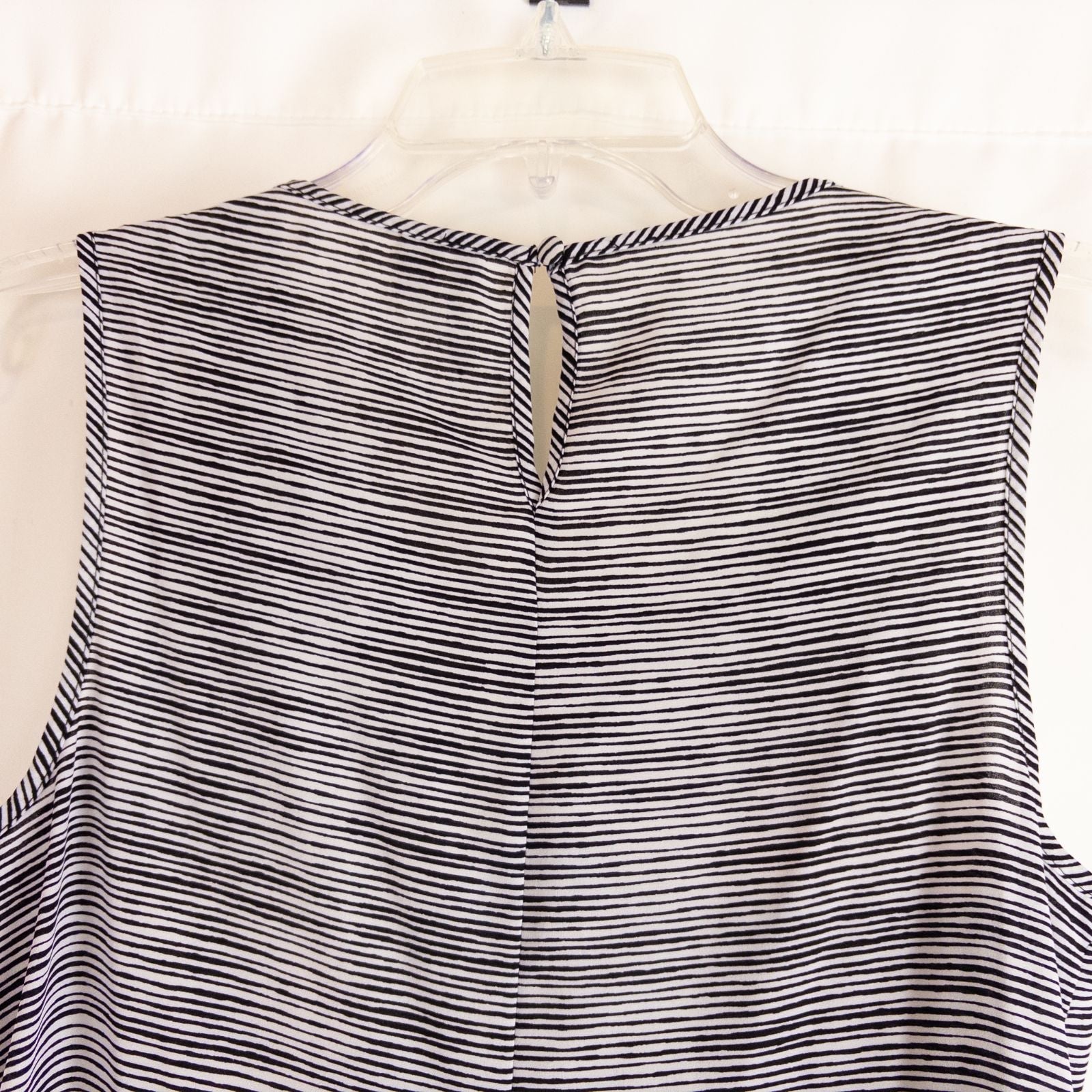 Elle black and white striped sleeveless tank top with peplum hem on clear hanger image 5