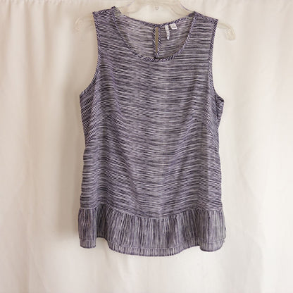 Elle black and white striped sleeveless tank top with peplum hem on clear hanger