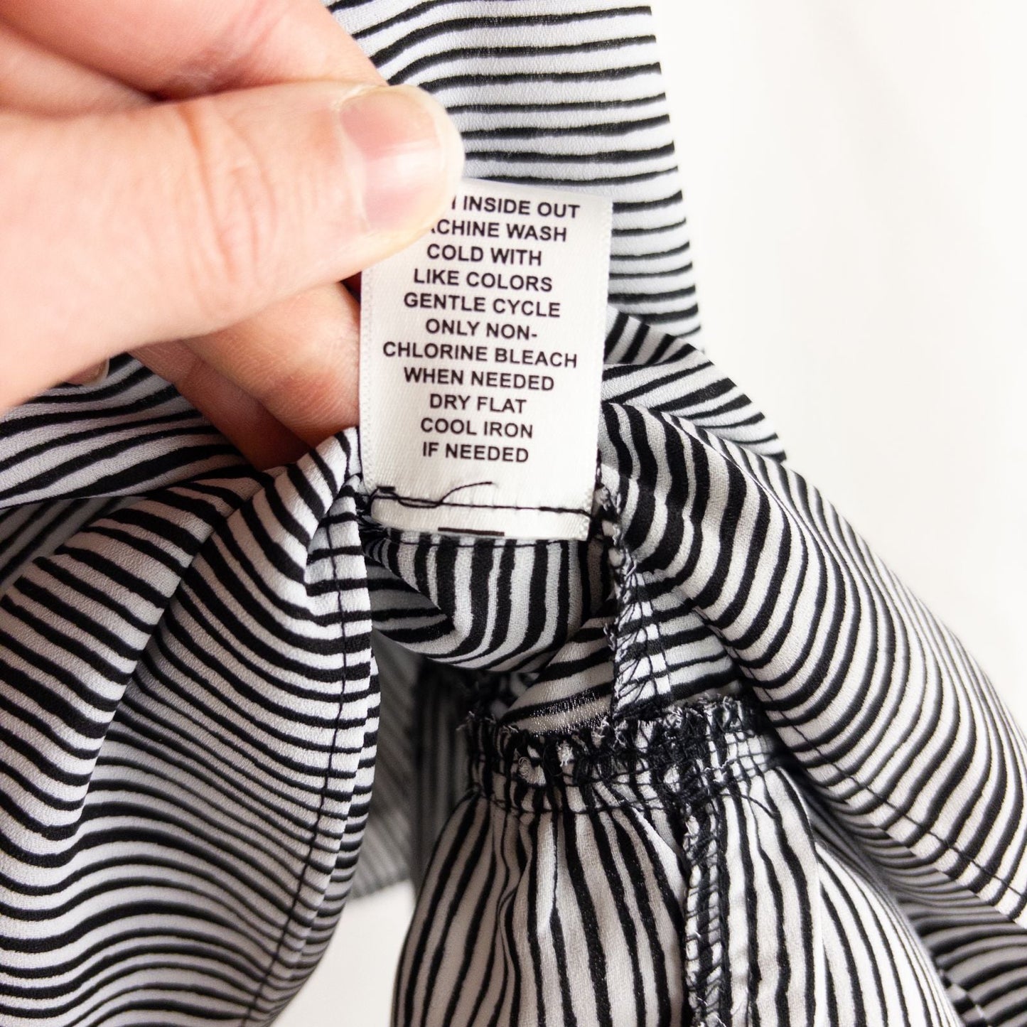 Elle black and white striped sleeveless tank top with peplum hem on clear hanger image 8