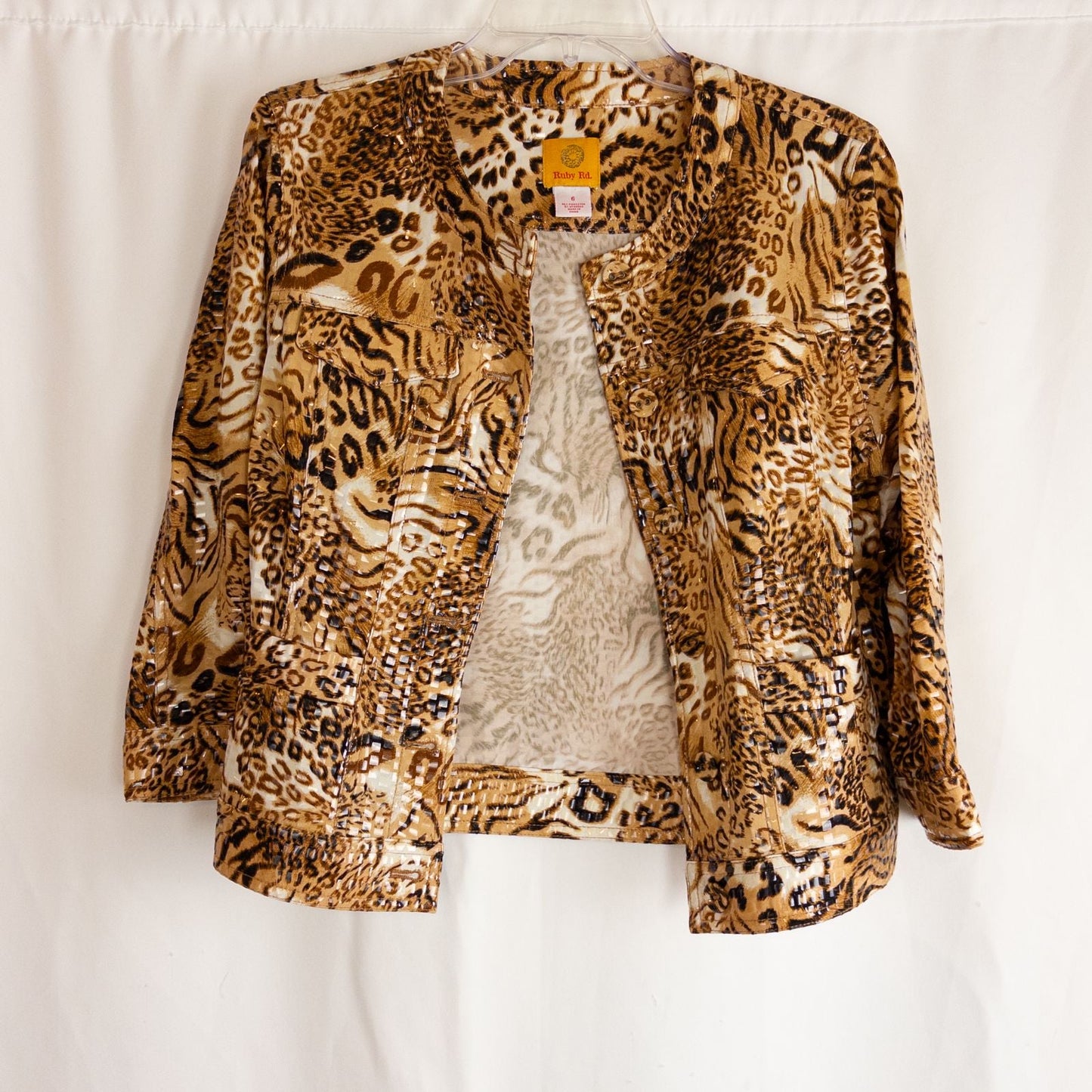 Ruby Rd brown cheetah print sequin button front jacket with four front pockets on clear hanger