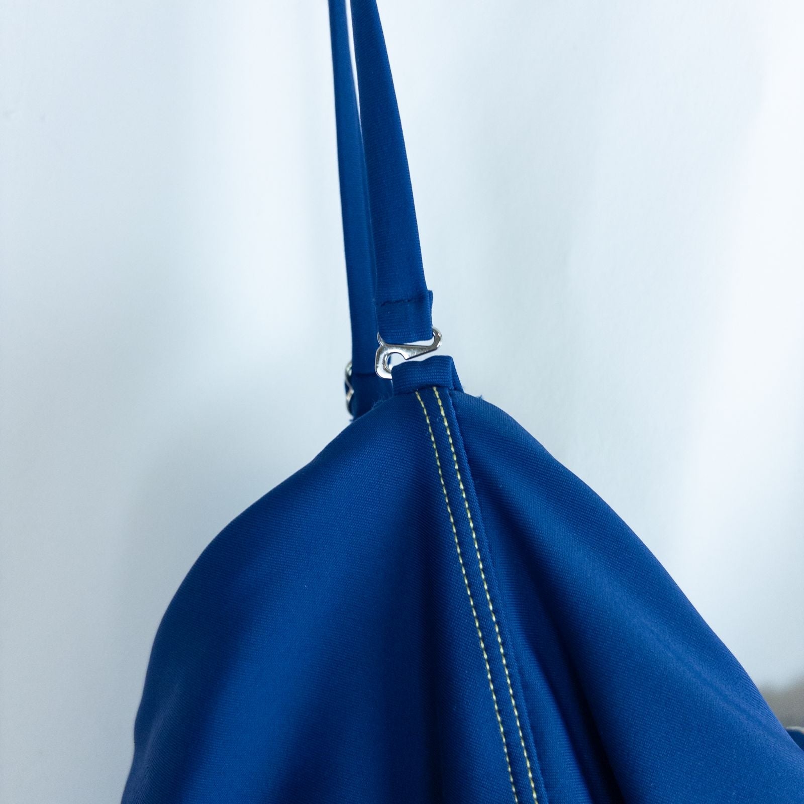 Blue Cupshe one piece swimsuit with cutout and knot detailing front view on hanger image 3