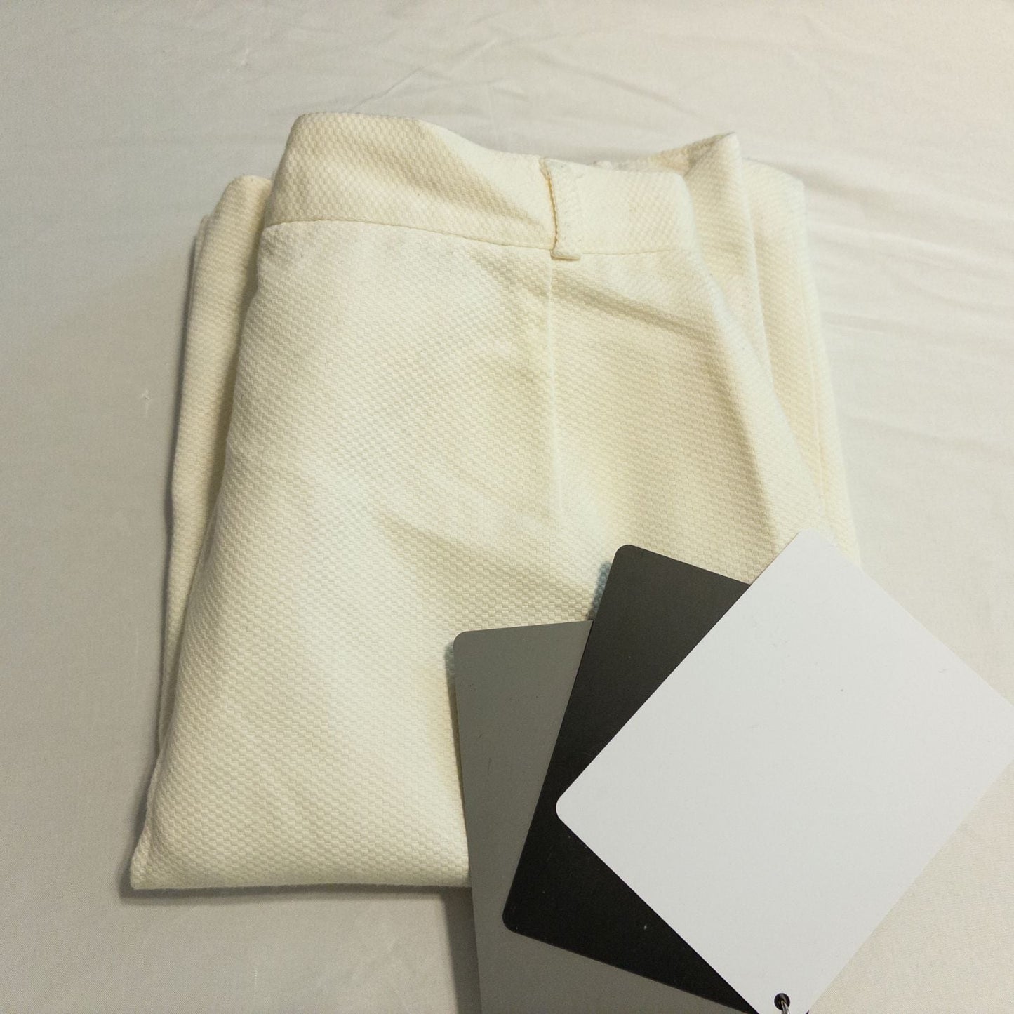 Vintage ivory pique pencil skirt with side zipper and button tab detail hanging on a hanger image 13