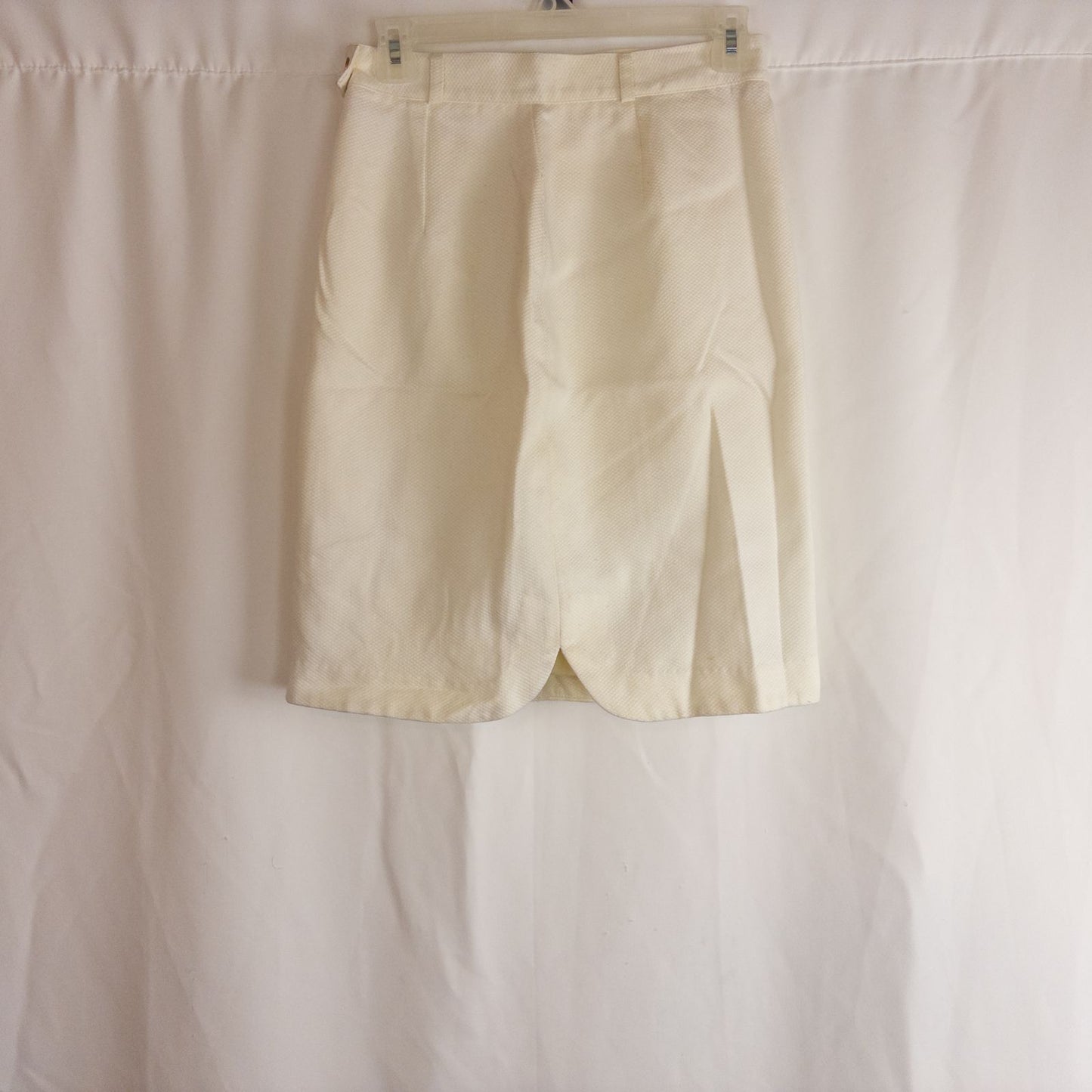 Vintage ivory pique pencil skirt with side zipper and button tab detail hanging on a hanger image 6