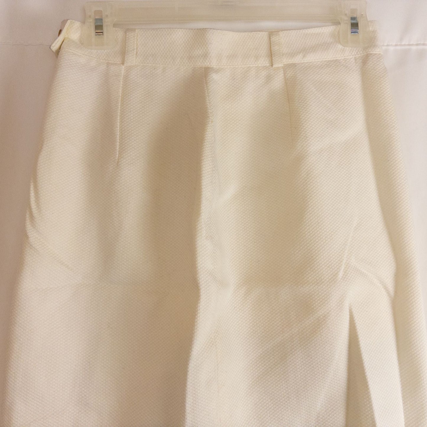 Vintage ivory pique pencil skirt with side zipper and button tab detail hanging on a hanger image 7