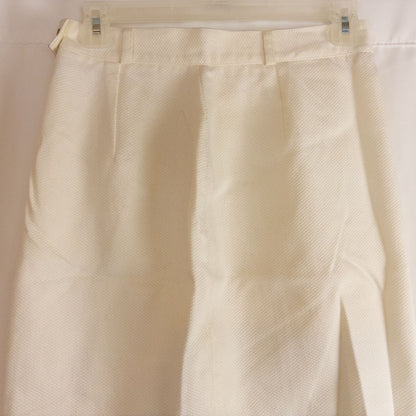 Vintage ivory pique pencil skirt with side zipper and button tab detail hanging on a hanger image 7