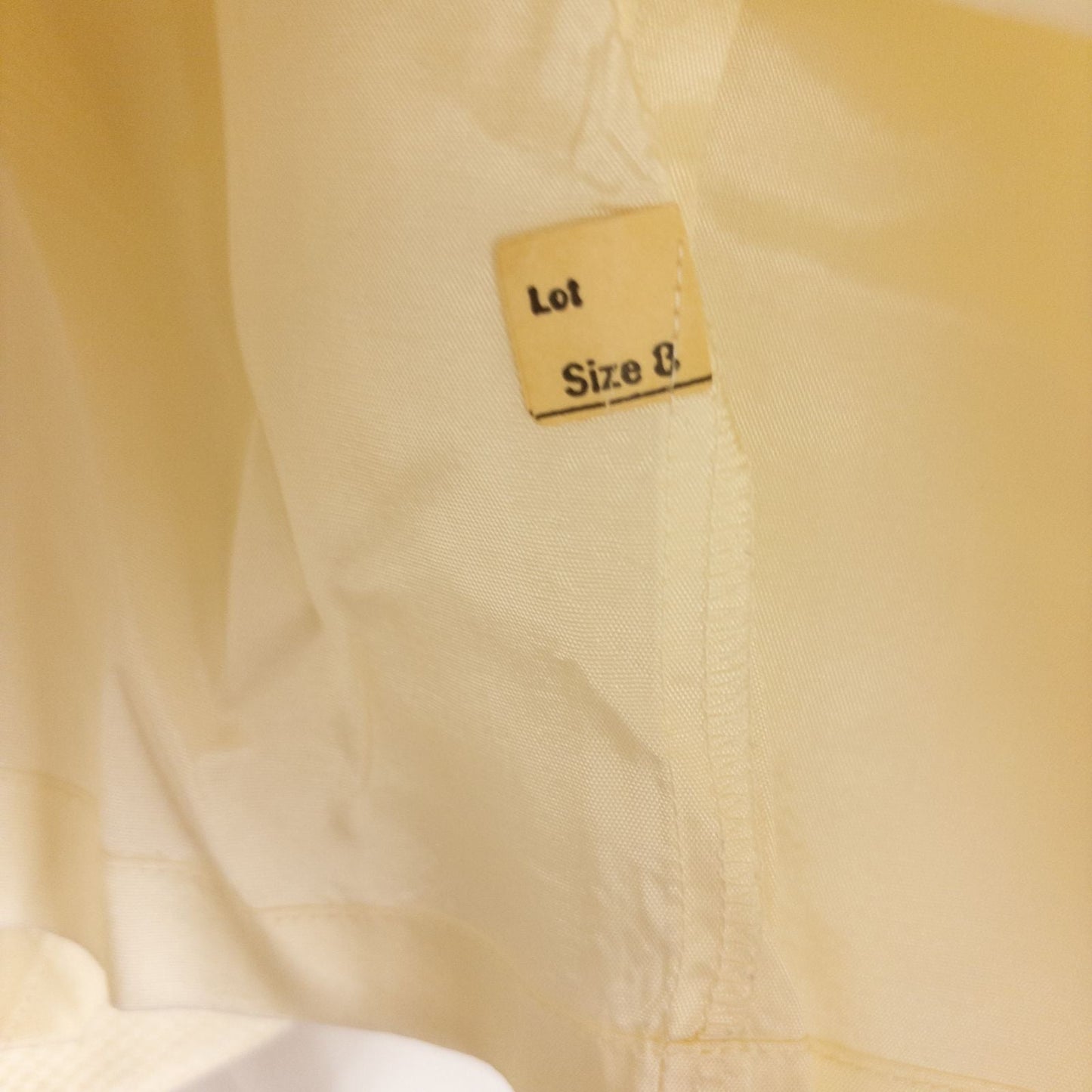 Vintage ivory pique pencil skirt with side zipper and button tab detail hanging on a hanger image 12