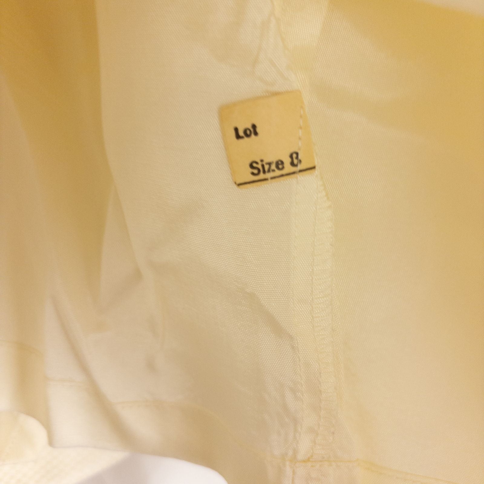 Vintage ivory pique pencil skirt with side zipper and button tab detail hanging on a hanger image 12