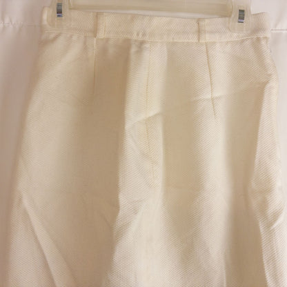 Vintage ivory pique pencil skirt with side zipper and button tab detail hanging on a hanger image 2