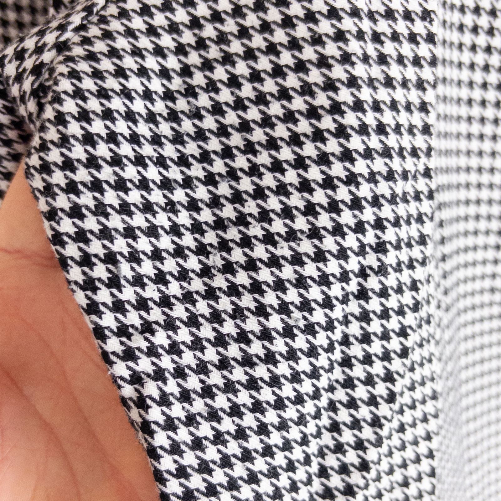 Mercer Culinary black and white houndstooth high rise pants in womens small size hanging on plastic hanger against white background showing front, side pockets, and back Mercer Culinary logo image 9