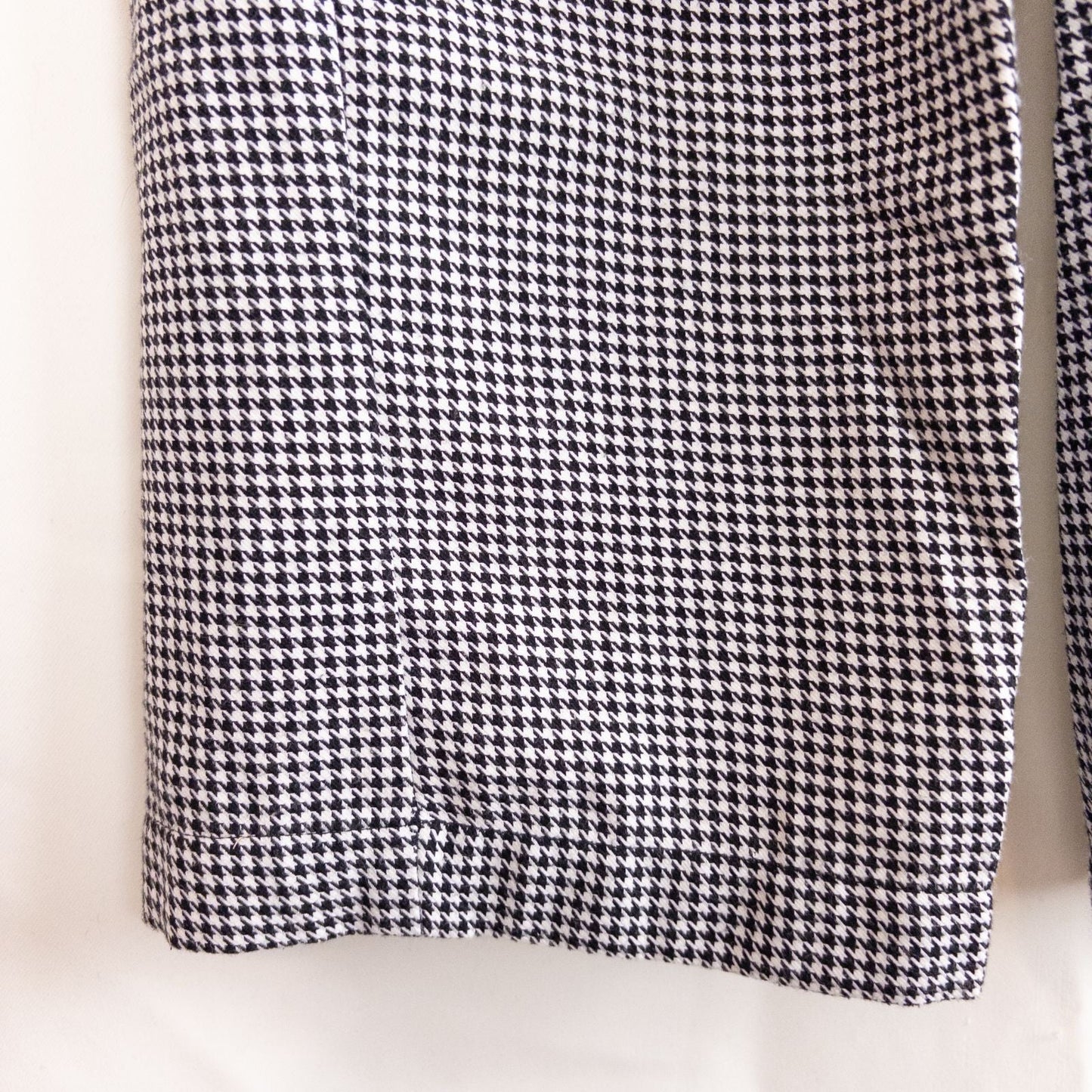 Mercer Culinary black and white houndstooth high rise pants in womens small size hanging on plastic hanger against white background showing front, side pockets, and back Mercer Culinary logo image 7