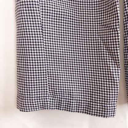 Mercer Culinary black and white houndstooth high rise pants in womens small size hanging on plastic hanger against white background showing front, side pockets, and back Mercer Culinary logo image 7