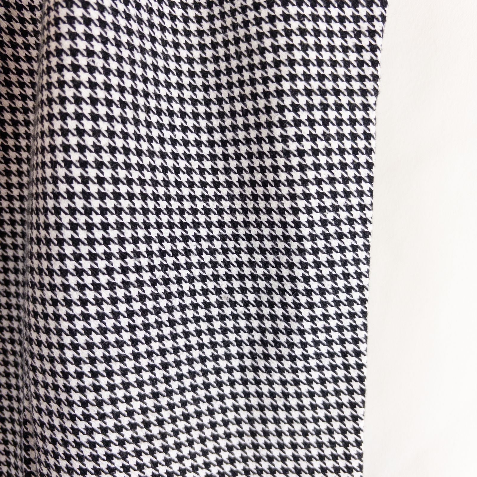 Mercer Culinary black and white houndstooth high rise pants in womens small size hanging on plastic hanger against white background showing front, side pockets, and back Mercer Culinary logo image 5