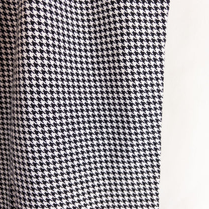 Mercer Culinary black and white houndstooth high rise pants in womens small size hanging on plastic hanger against white background showing front, side pockets, and back Mercer Culinary logo image 5