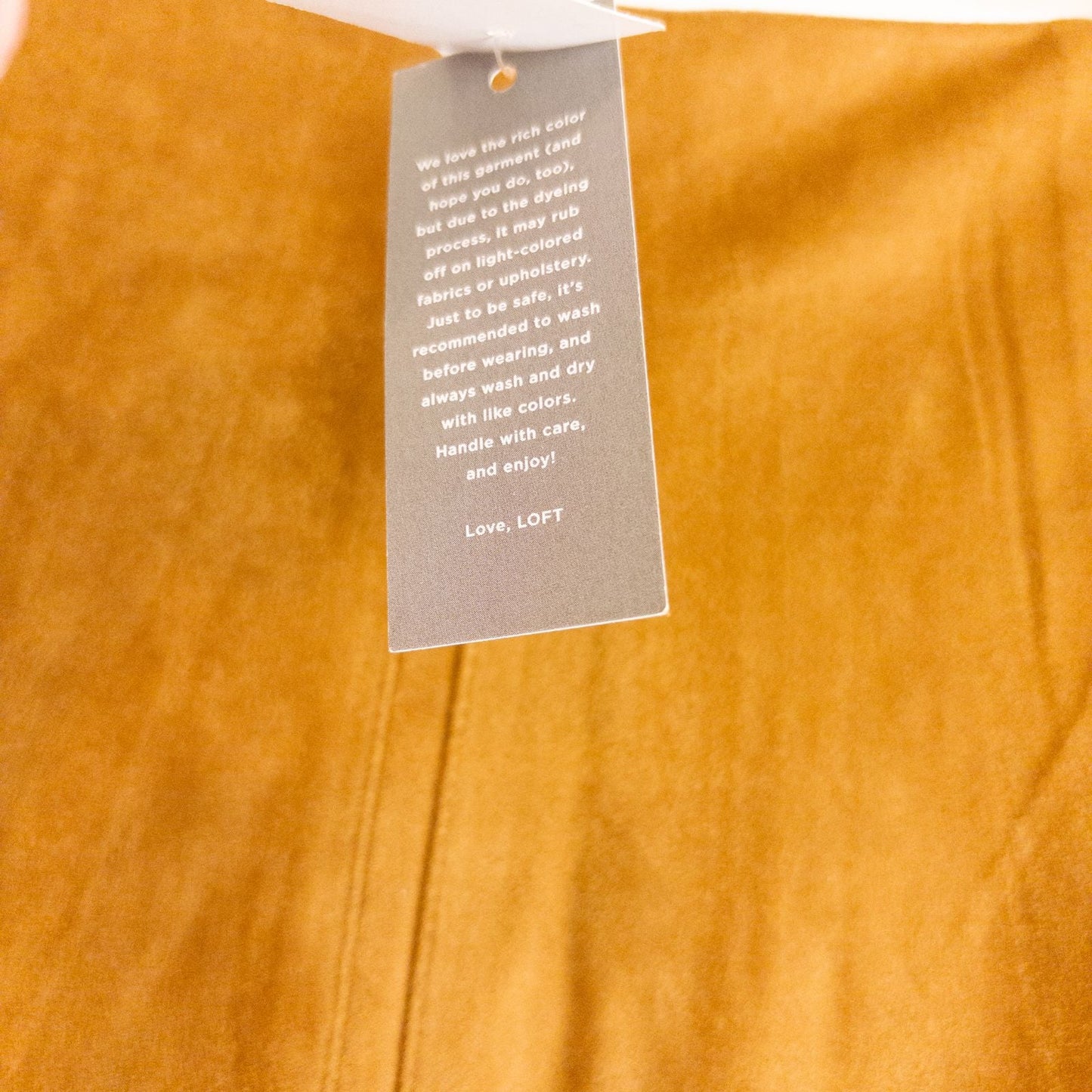 Loft brown suede flair mini skirt womens size 0 hanging on clear plastic hanger against white background image 8