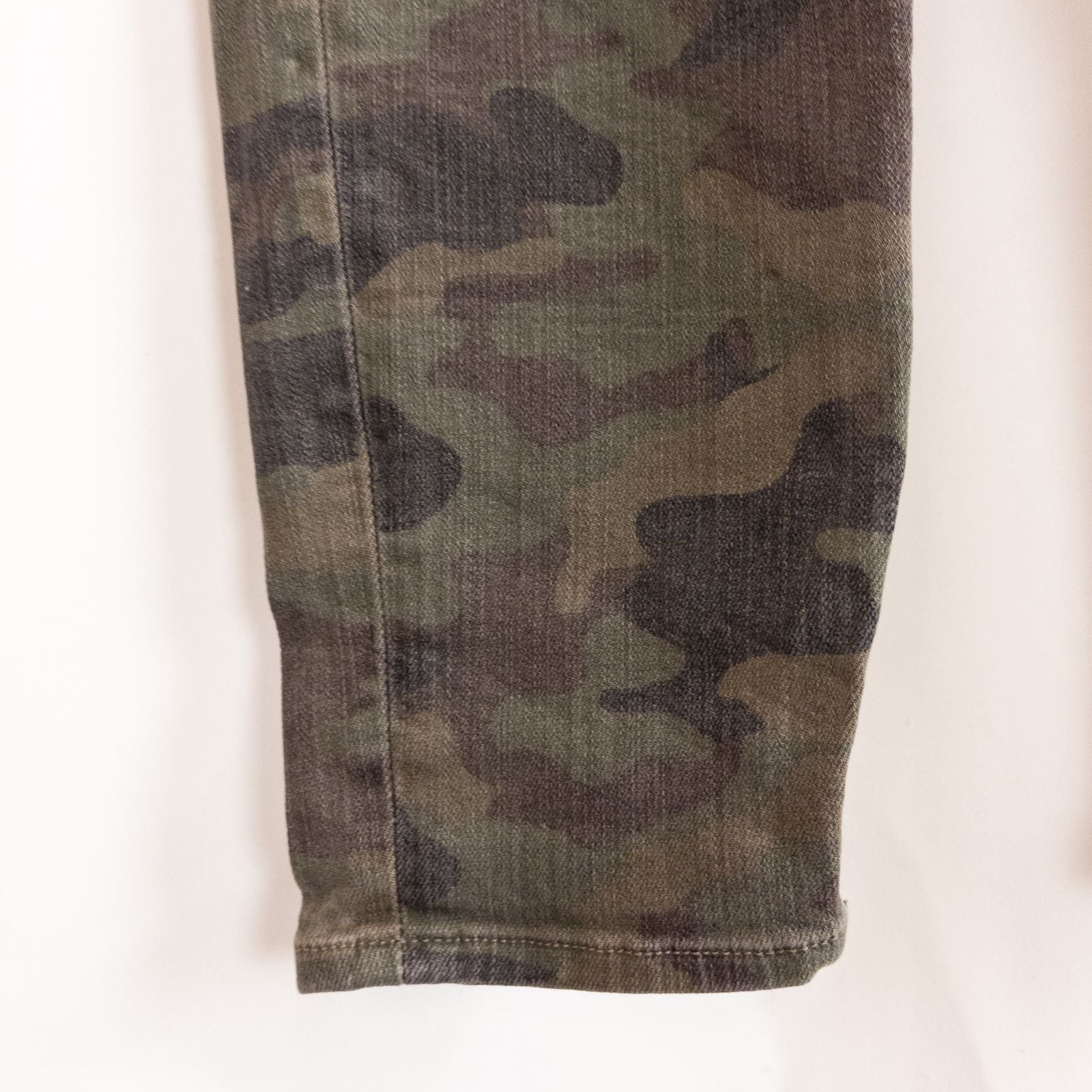 Hudson green camo skinny jeans womens size 31 with minimal wear and faux front pockets displayed hanging. image 7