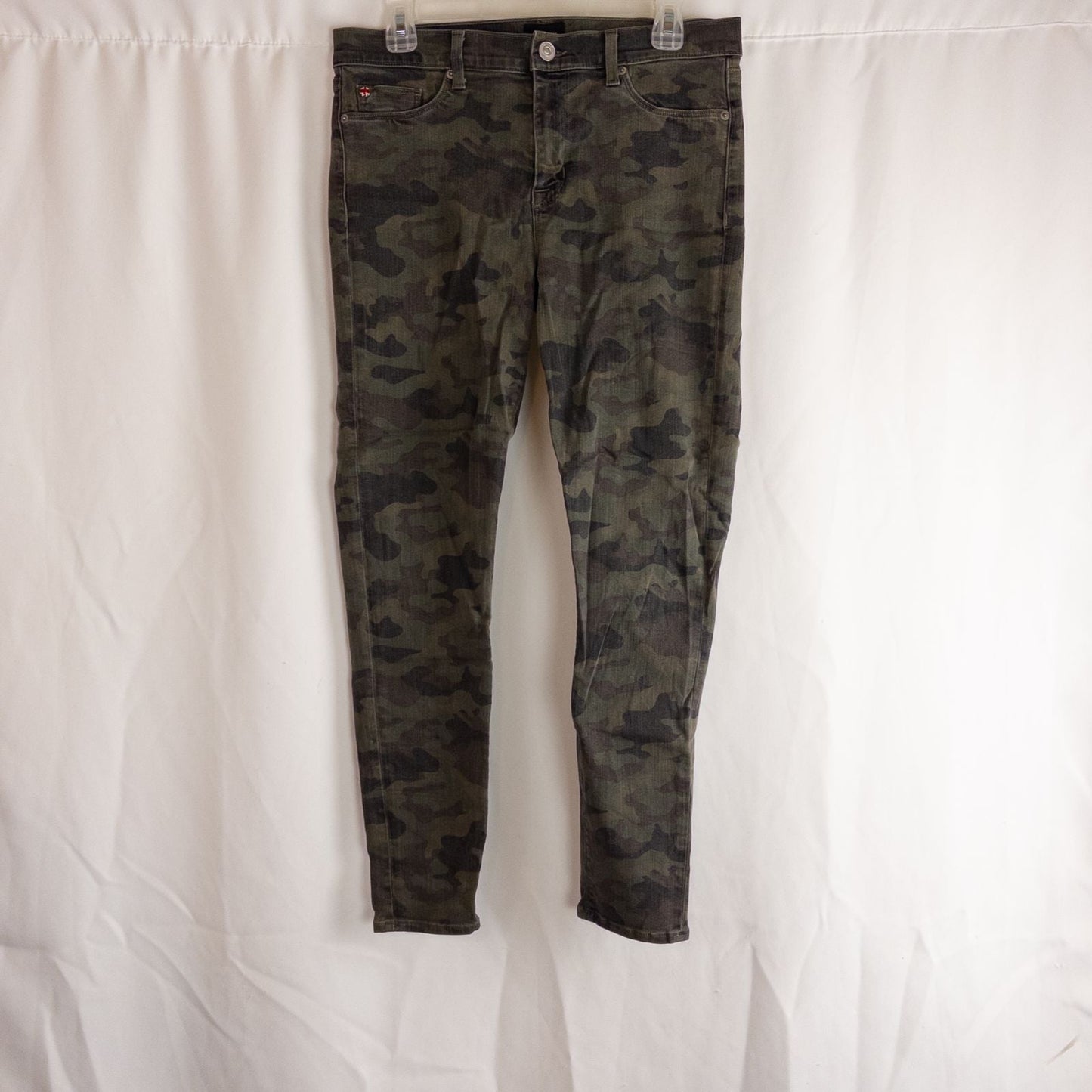 Hudson green camo skinny jeans womens size 31 with minimal wear and faux front pockets displayed hanging.