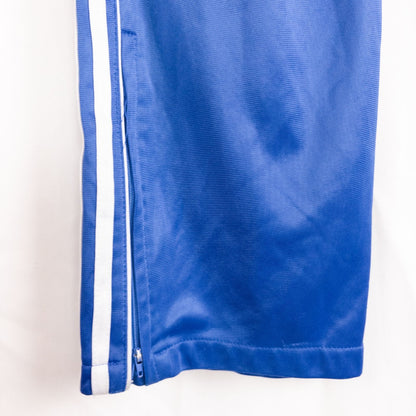 Blue DC Athletics track pants with white stripes down sides hanging on hanger front and back views with closeups of details image 8
