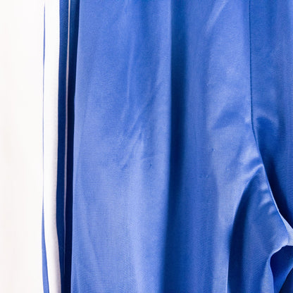 Blue DC Athletics track pants with white stripes down sides hanging on hanger front and back views with closeups of details image 6