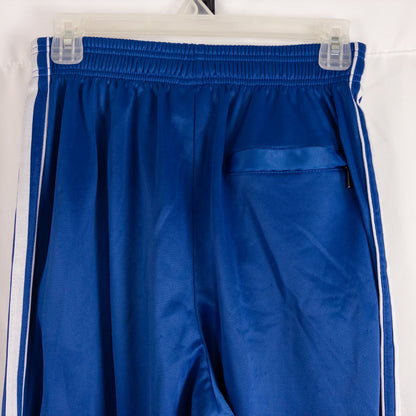 Blue DC Athletics track pants with white stripes down sides hanging on hanger front and back views with closeups of details image 4