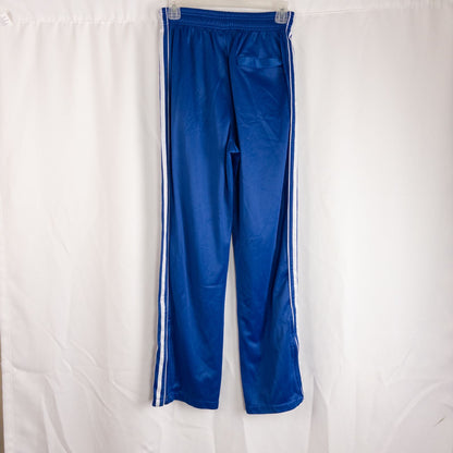 Blue DC Athletics track pants with white stripes down sides hanging on hanger front and back views with closeups of details image 3