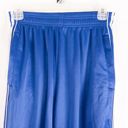 Blue DC Athletics track pants with white stripes down sides hanging on hanger front and back views with closeups of details image 2
