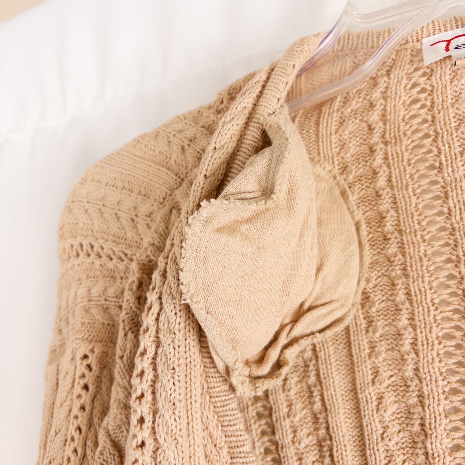 Talbots tan vintage cable knit cardigan sweater with button front and shoulder pads hanging on clear hanger image 5