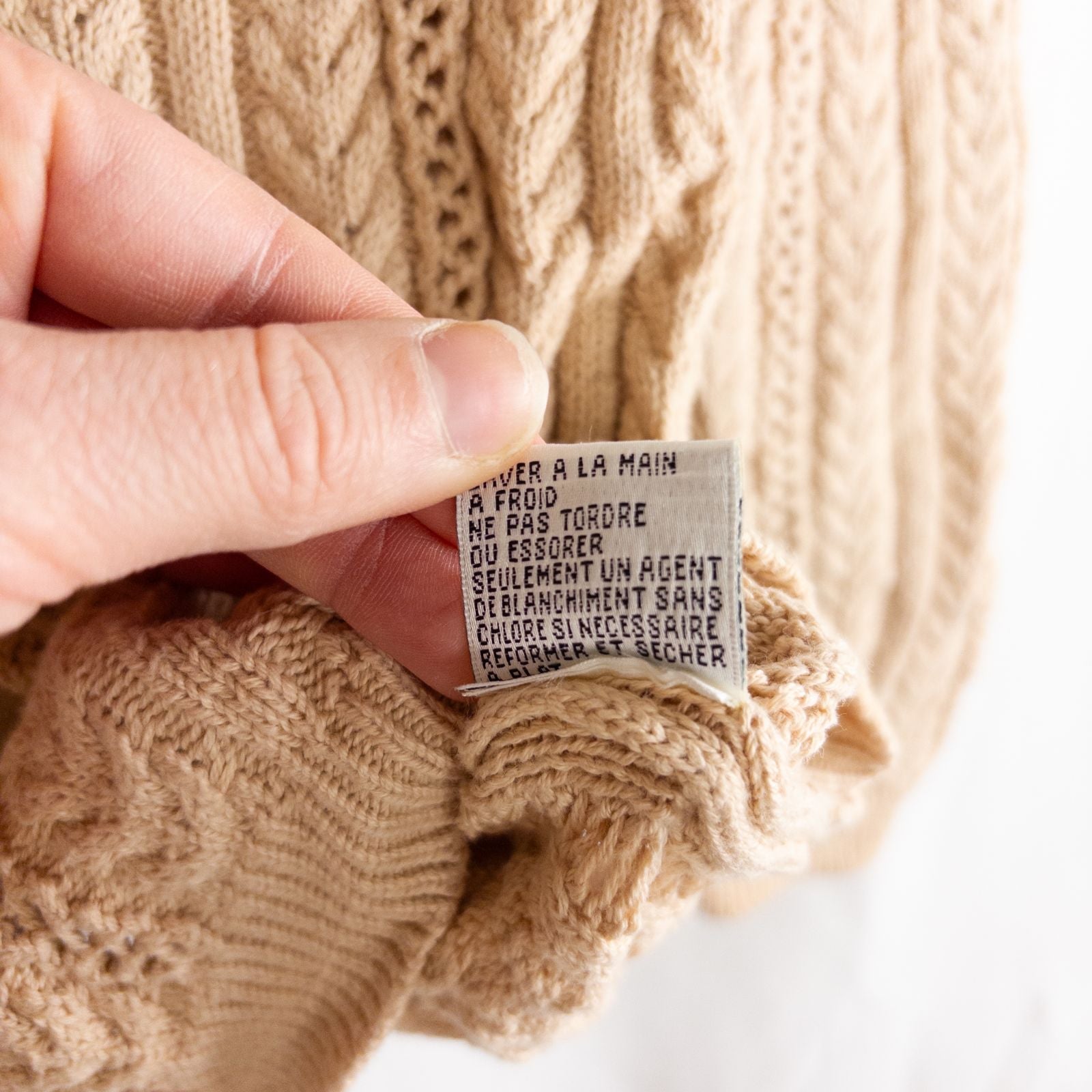 Talbots tan vintage cable knit cardigan sweater with button front and shoulder pads hanging on clear hanger image 9
