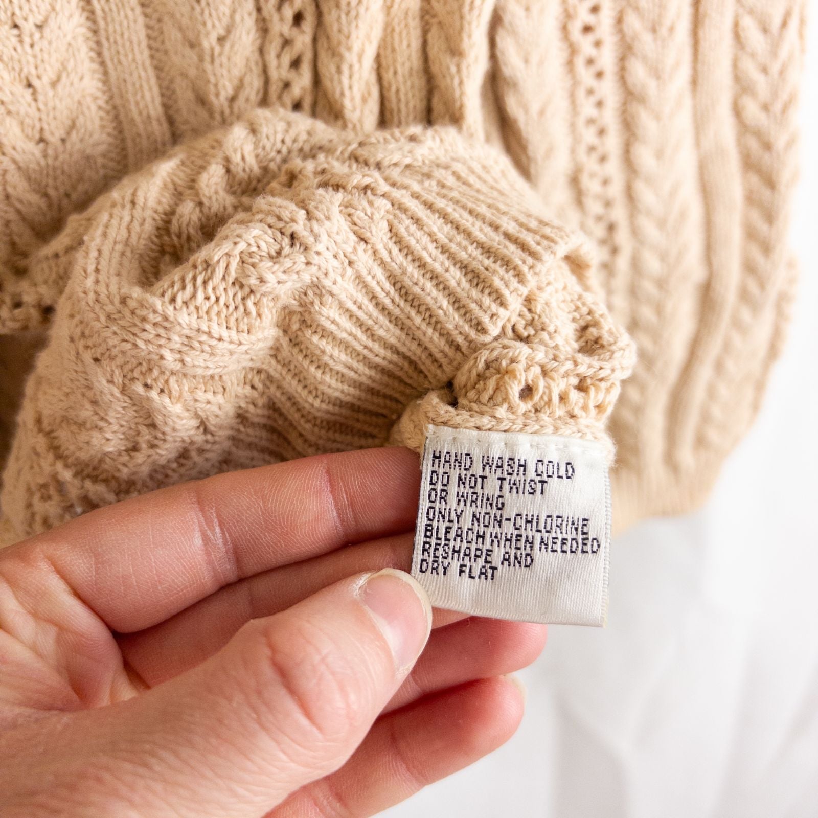 Talbots tan vintage cable knit cardigan sweater with button front and shoulder pads hanging on clear hanger image 8