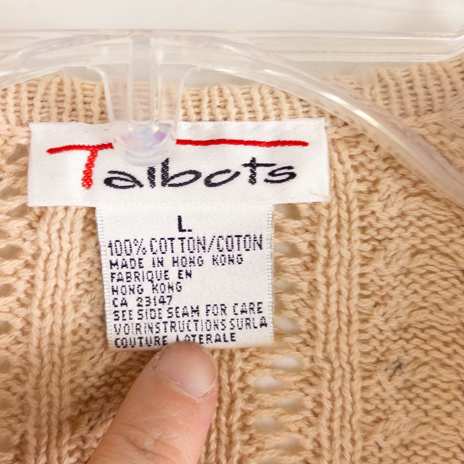 Talbots tan vintage cable knit cardigan sweater with button front and shoulder pads hanging on clear hanger image 7