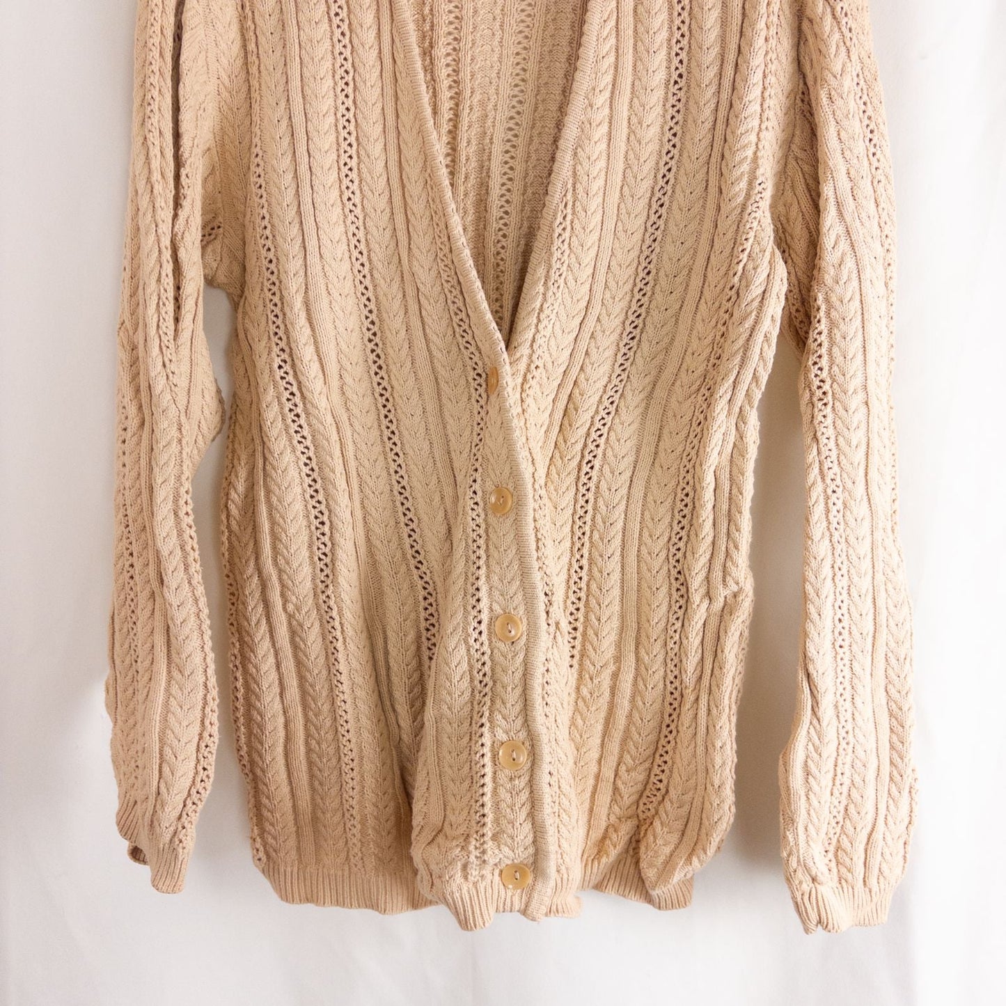 Talbots tan vintage cable knit cardigan sweater with button front and shoulder pads hanging on clear hanger image 3