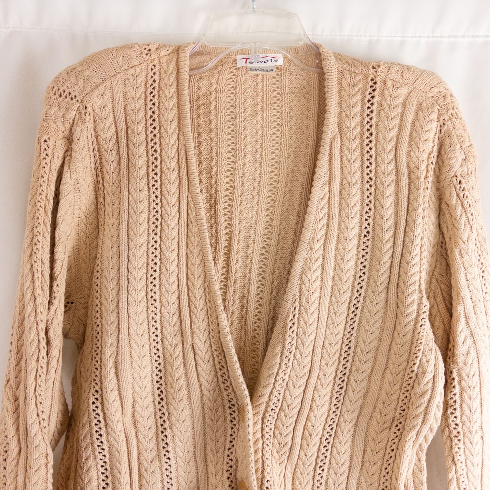 Talbots tan vintage cable knit cardigan sweater with button front and shoulder pads hanging on clear hanger image 2