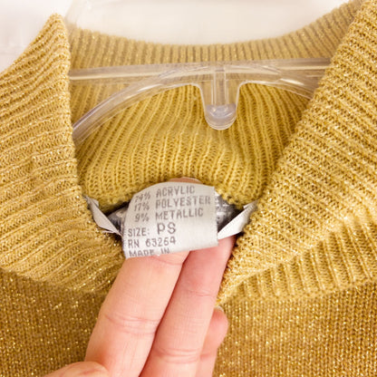 Dress Barn petite gold knit sweater with mock neck and long sleeves hung on a clear hanger image 7