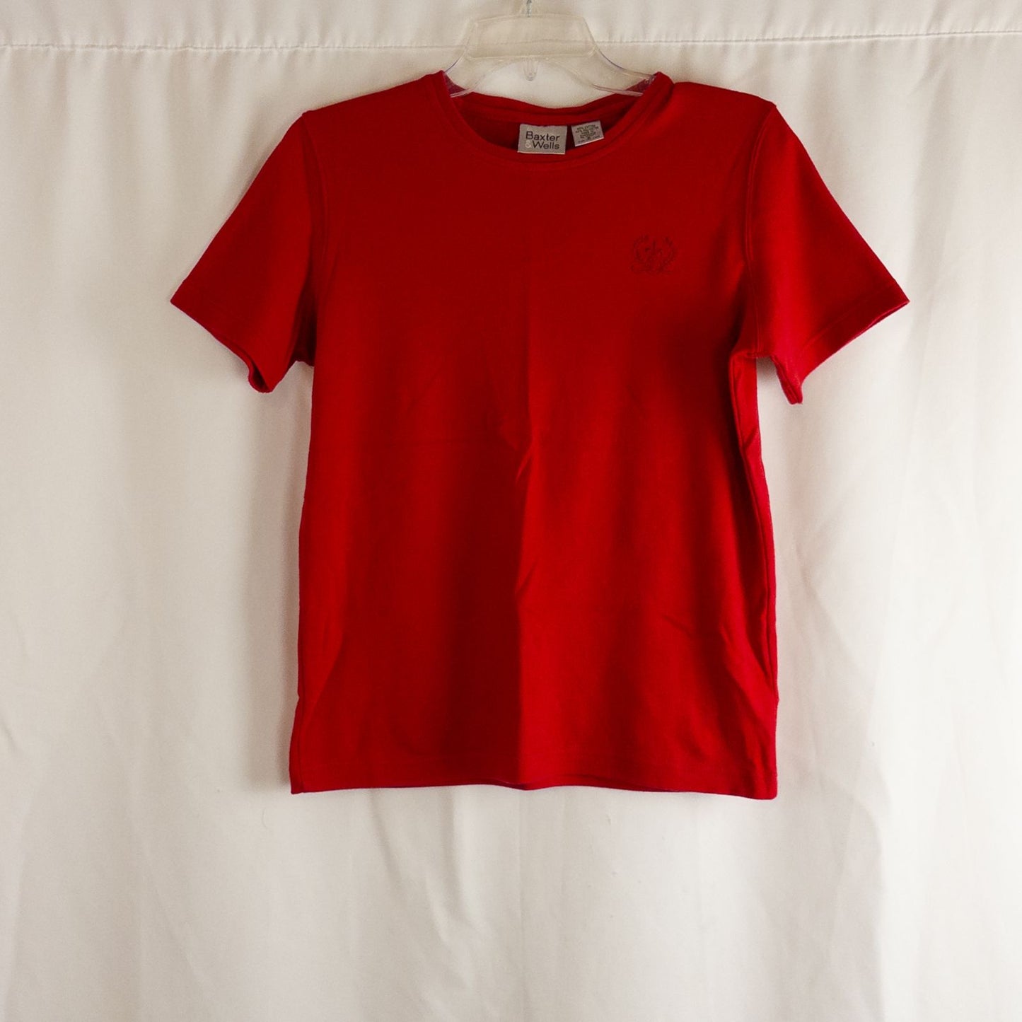 Baxter & Wells vintage red short sleeve t shirt with embroidered logo on chest hanging on clear hanger