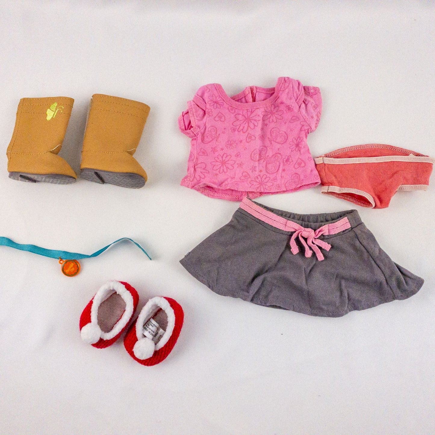 American Girl Pink Shirt Skirt Underwear Boots Outfit with Dog Collar and Holiday Slippers in laid flat display on white background