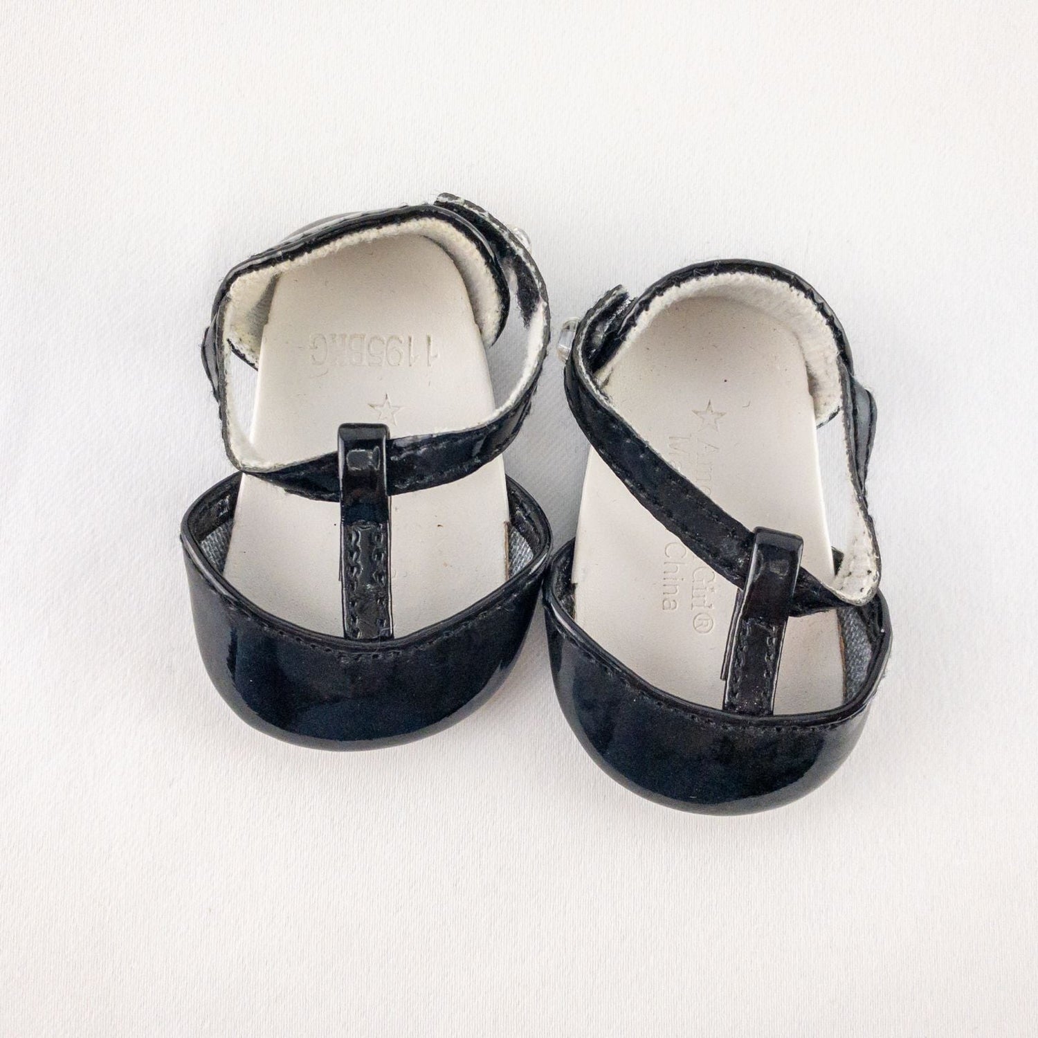 Pair of American Girl Joyful Jewels black doll shoes with rhinestone detail, viewed from front, side, and bottom angles.