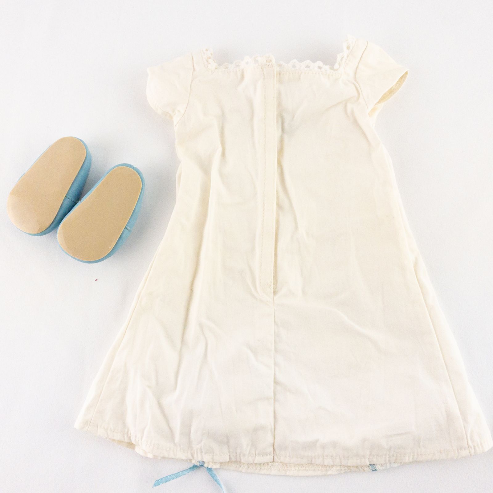 American Girl Caroline cream nightgown dress with blue ribbon detail and matching light blue doll shoes laid flat image 4