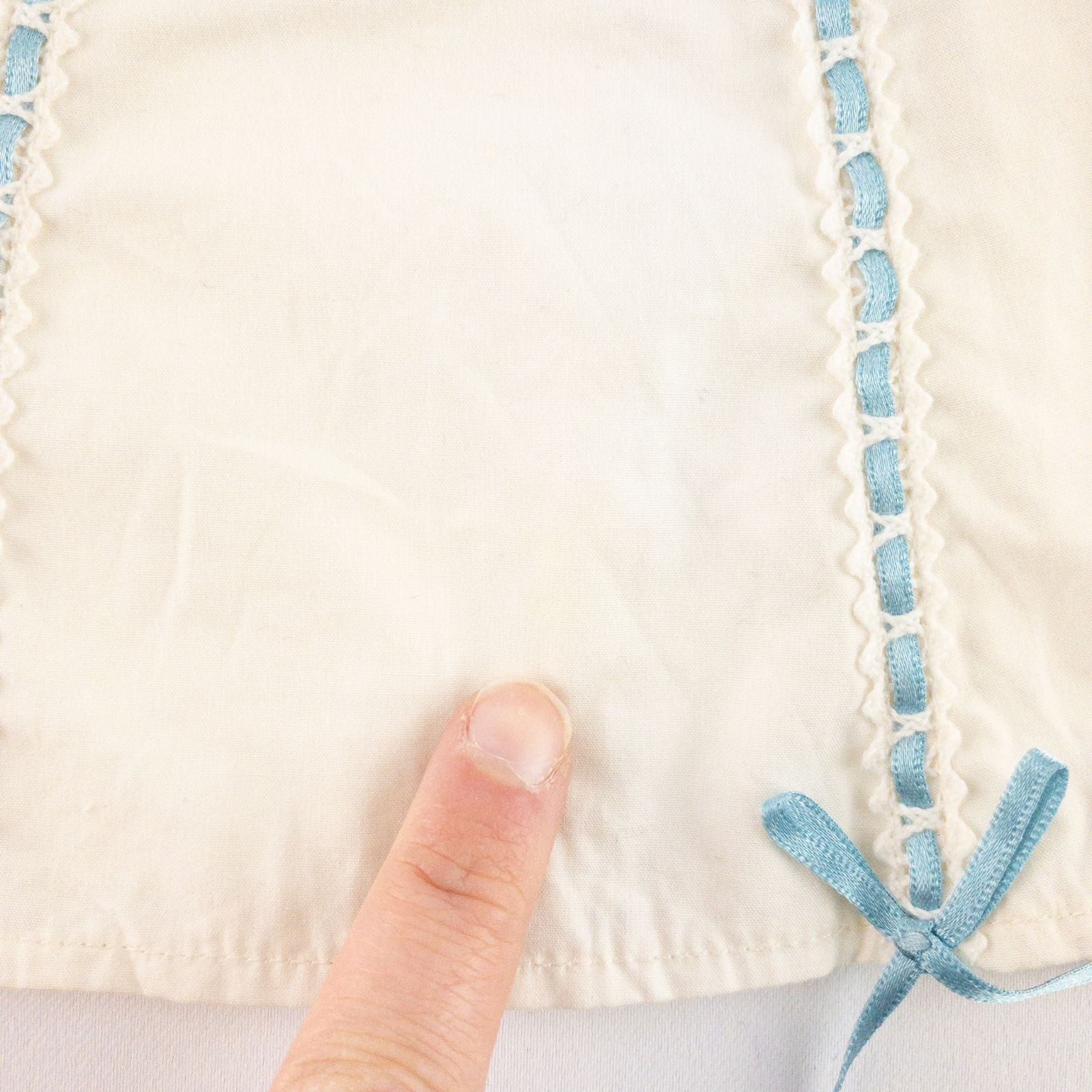 American Girl Caroline cream nightgown dress with blue ribbon detail and matching light blue doll shoes laid flat image 3