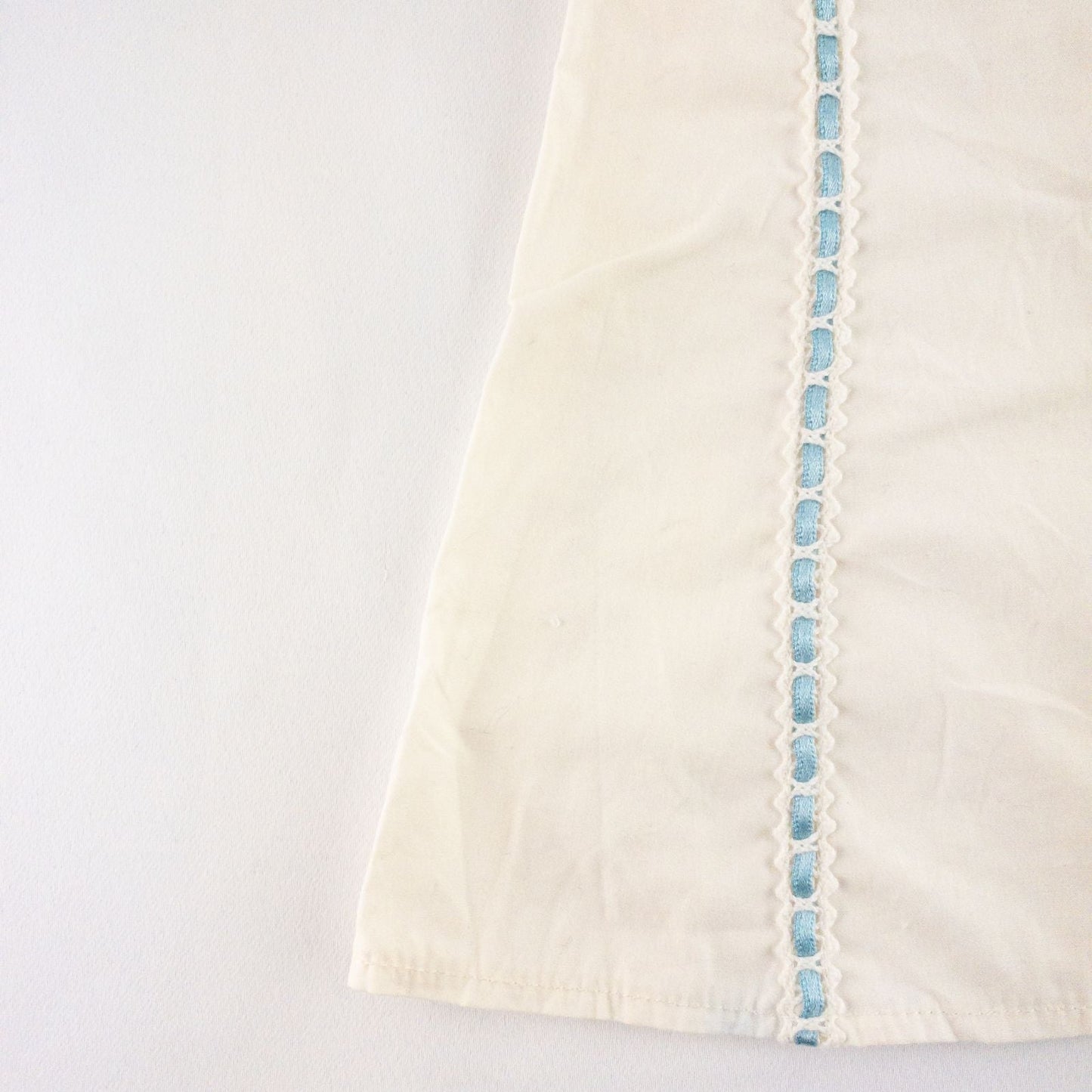 American Girl Caroline cream nightgown dress with blue ribbon detail and matching light blue doll shoes laid flat image 2